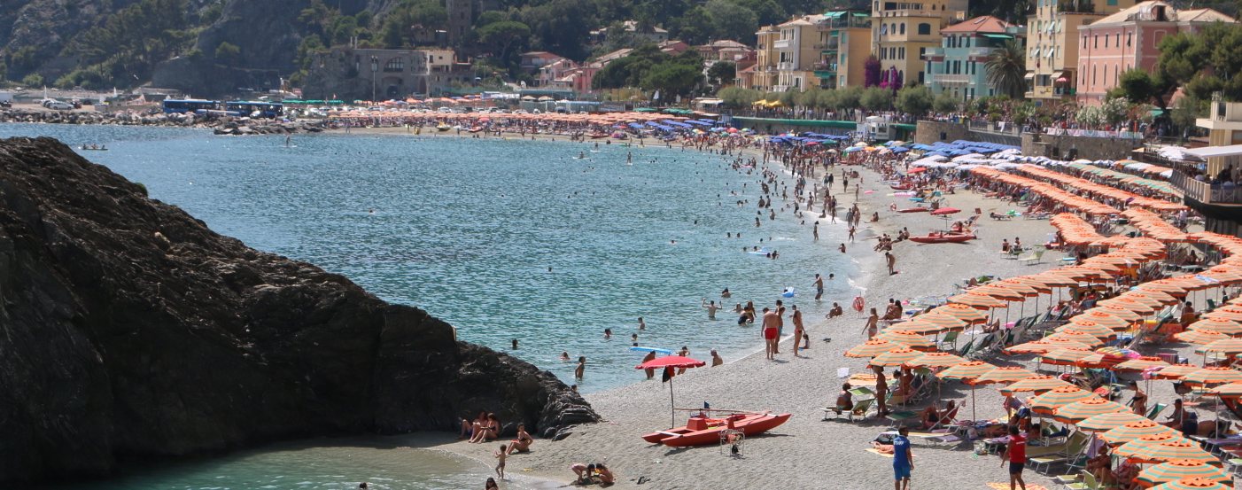 Monterosso beach with striped umbrellas on the Italian Riviera